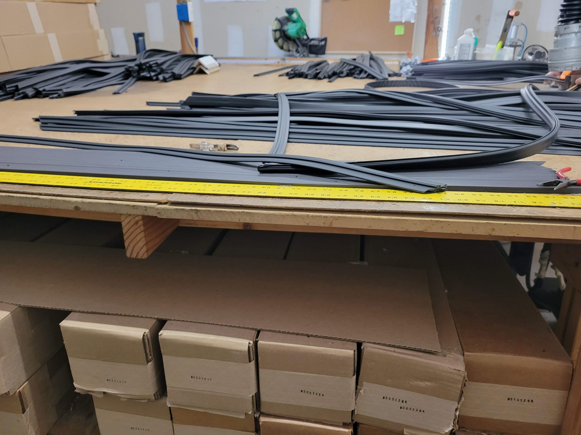 Custom-fabricated refrigeration gaskets laid out on a Pro Gasket Group workbench