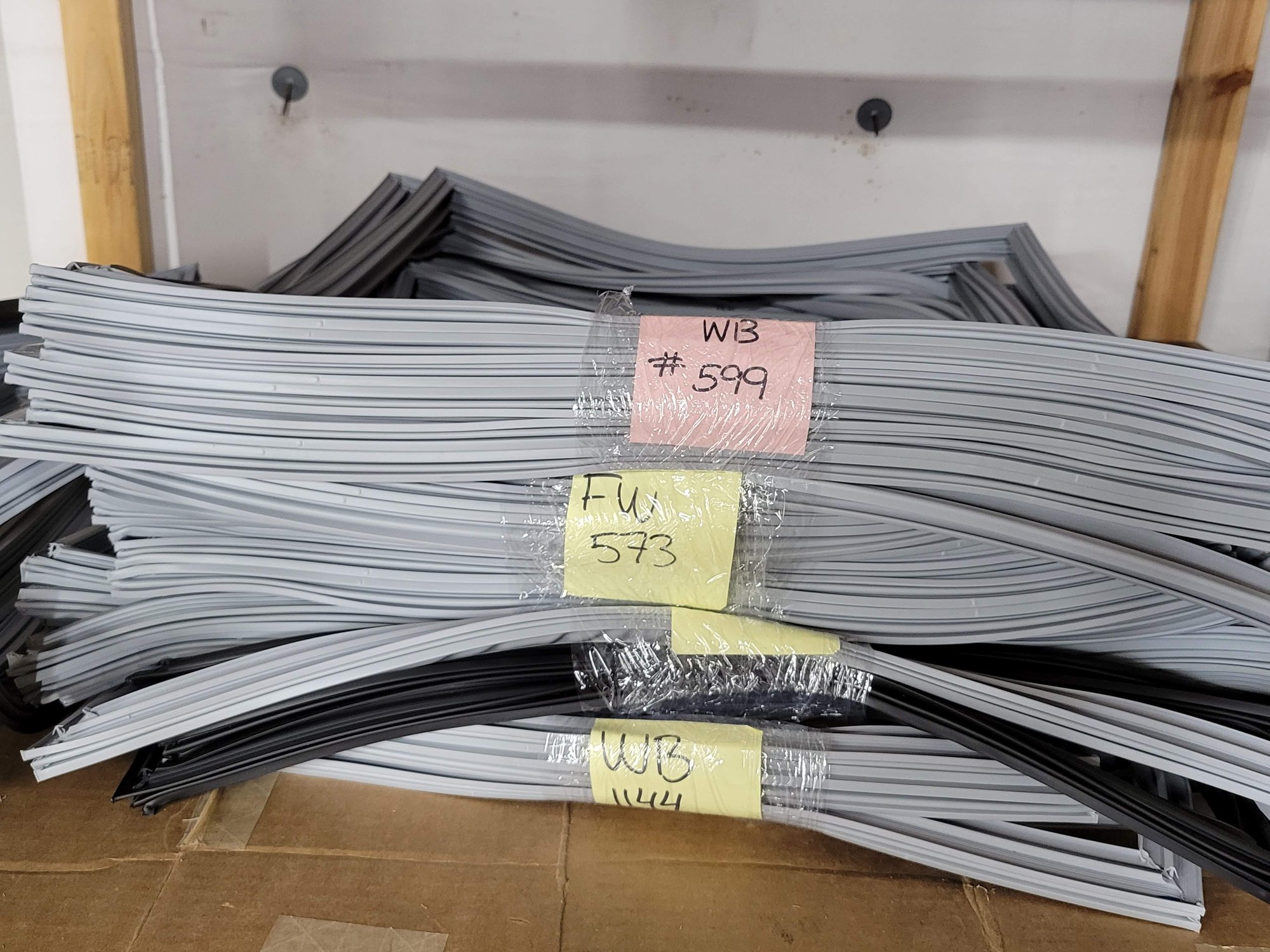 Bundled, tagged refrigeration gaskets labeled by asset Tag number